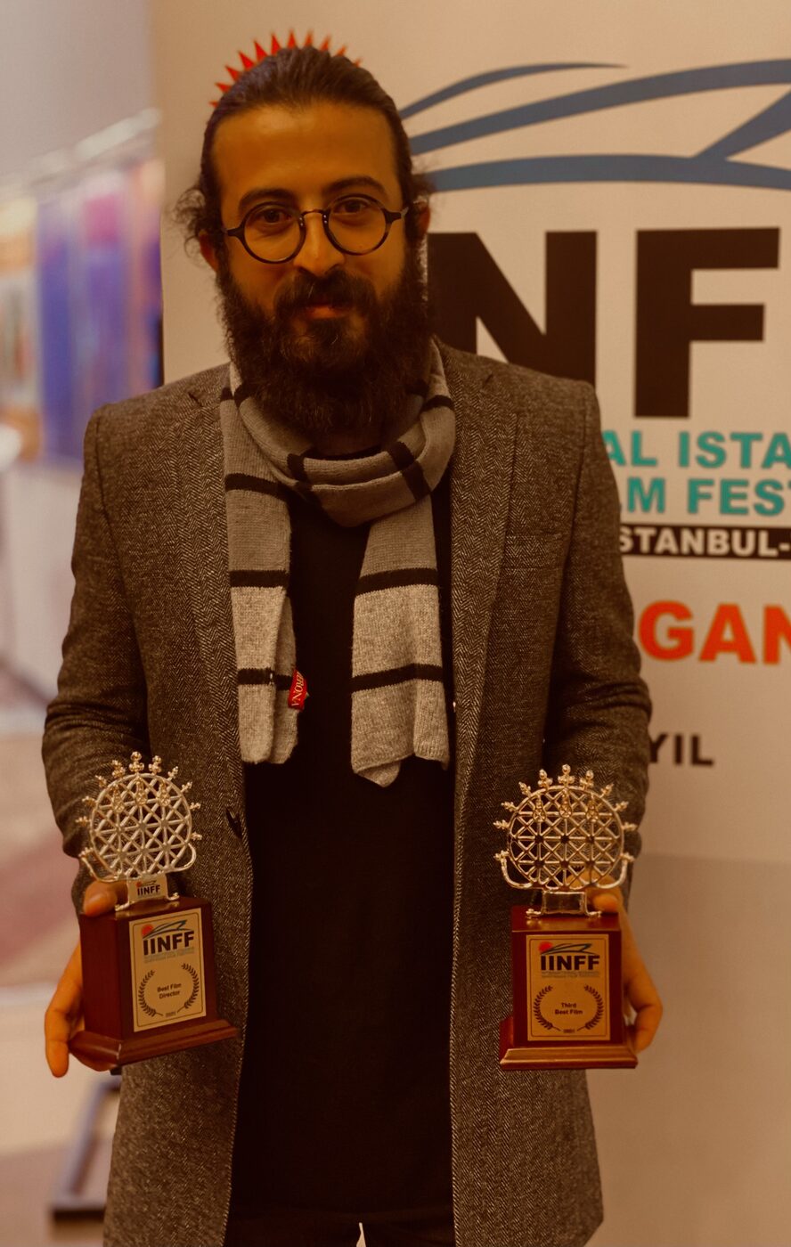 Milad Mansouri with his Best Film Director and Third Best Film trophies from the International Istanbul National Film Festival (IINFF)